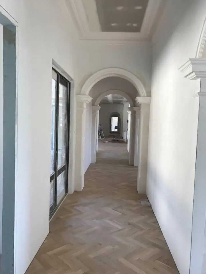 Arched hallway painted in clean white