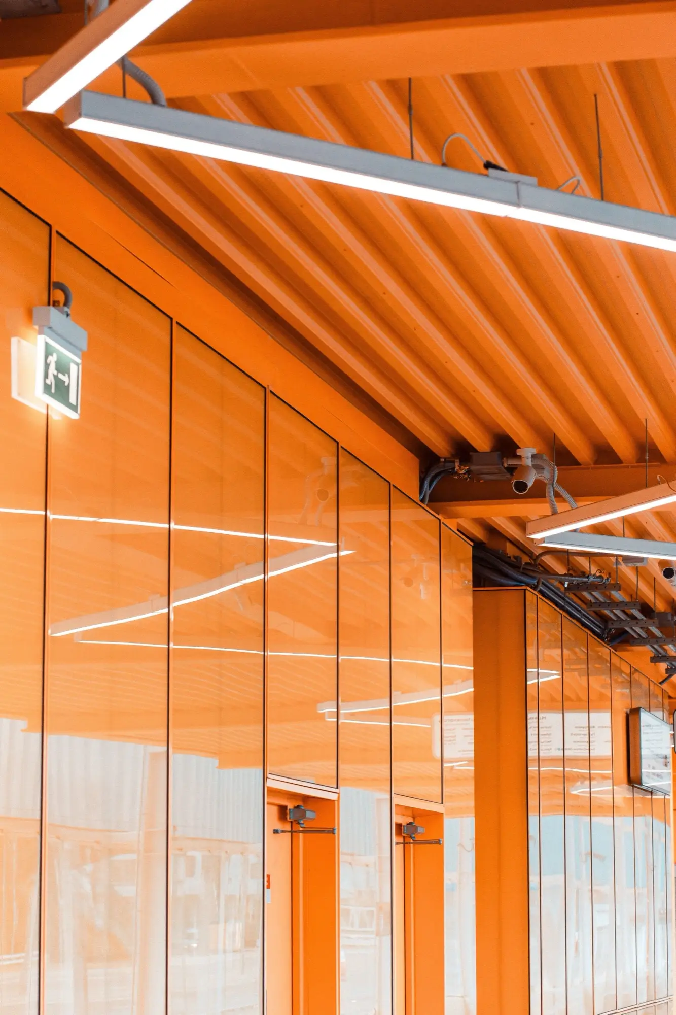 Bold orange commercial interior with painted ceiling and glazed partitions