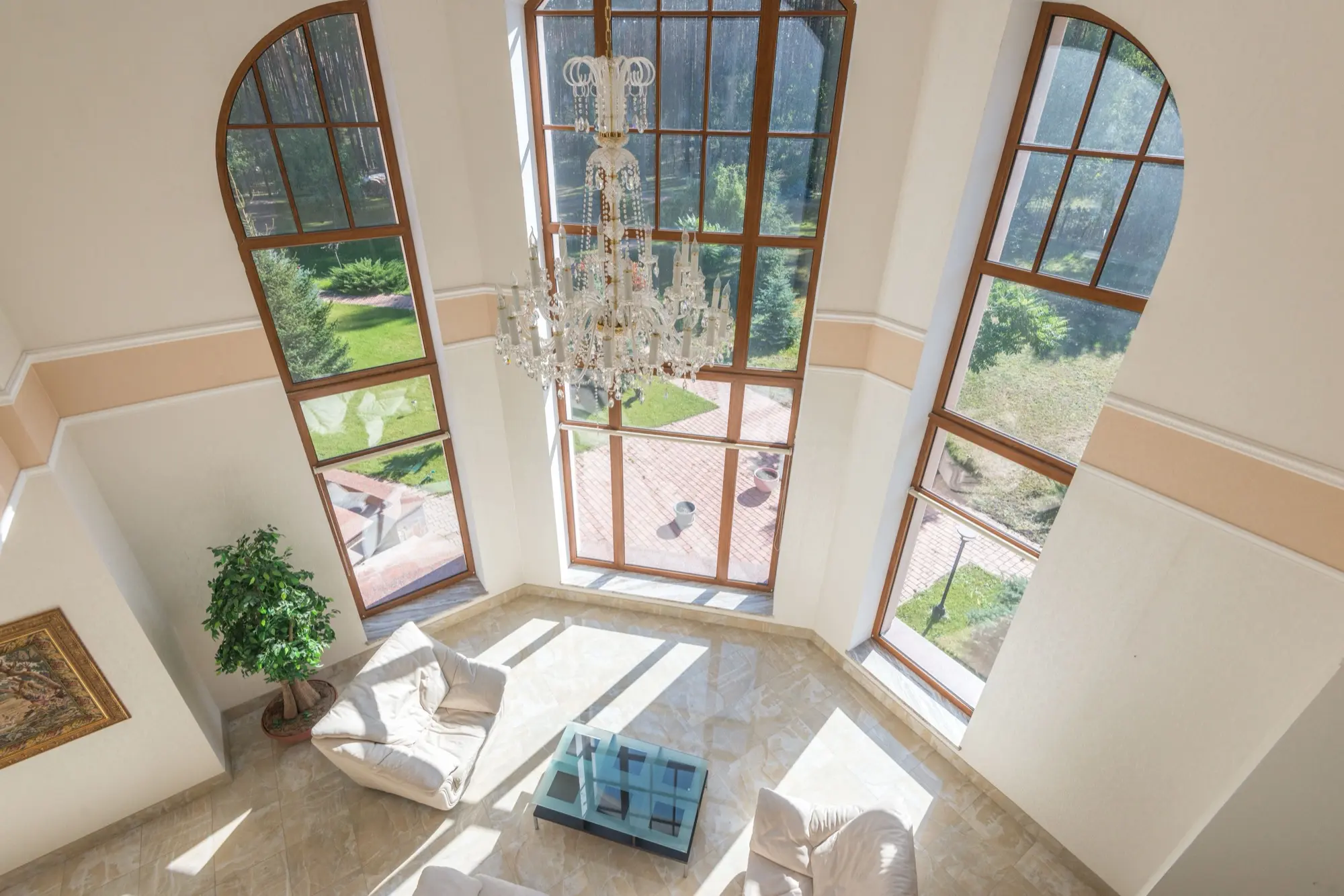Bright, freshly painted living space with high windows and natural light