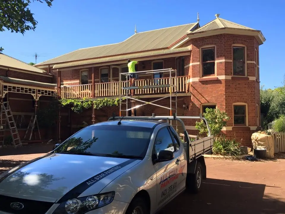 Heritage brick building with scaffold and work ute