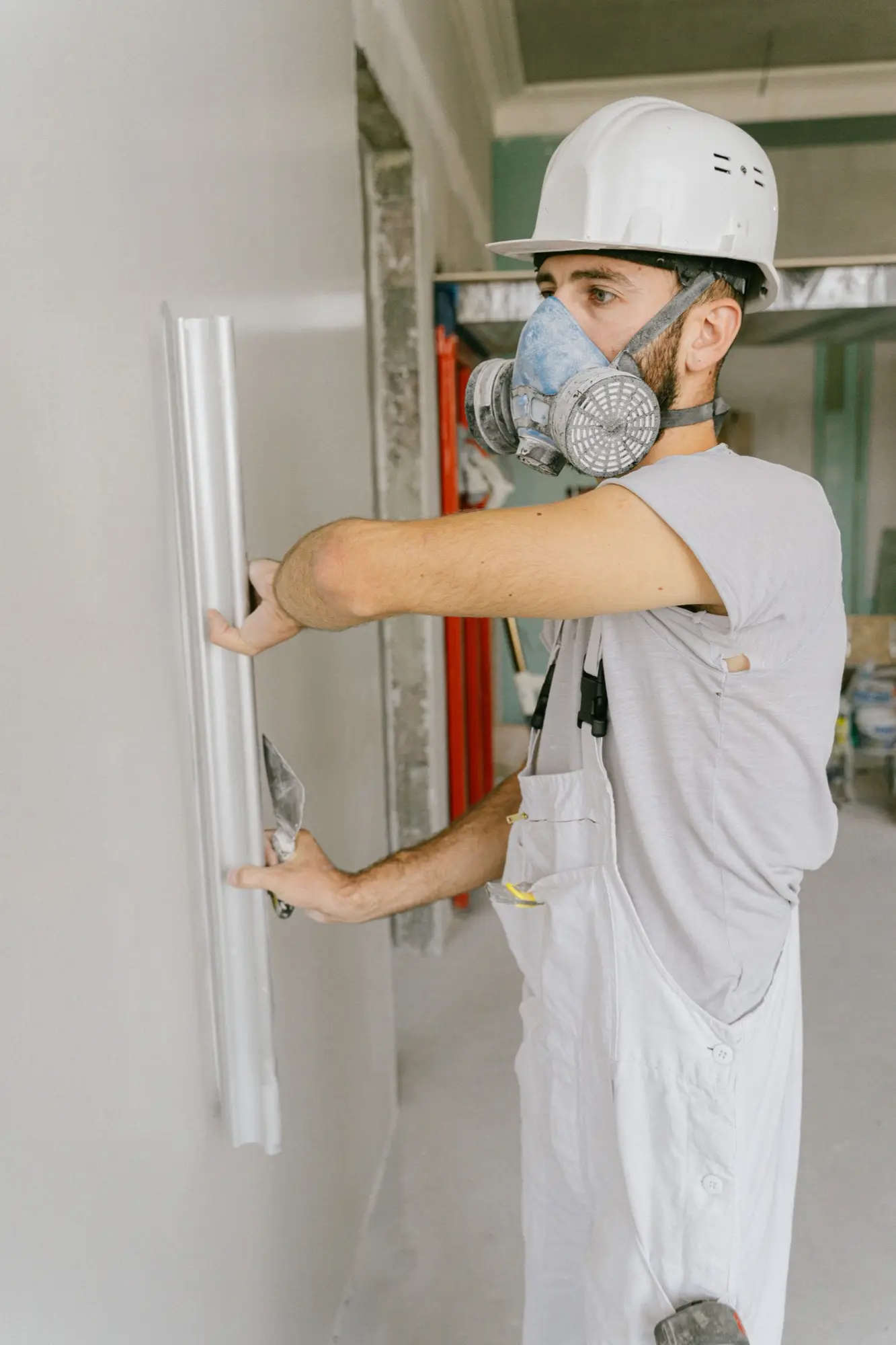 All Star painter running a level along a freshly prepared wall